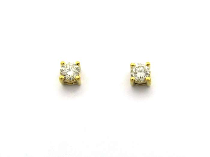 18K gold diamond stud earrings.