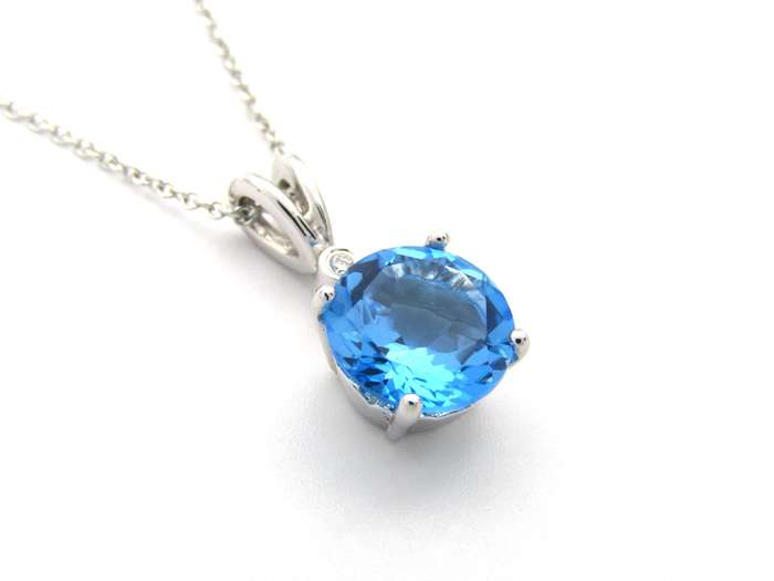9K gold blue topaz and diamond pendant.