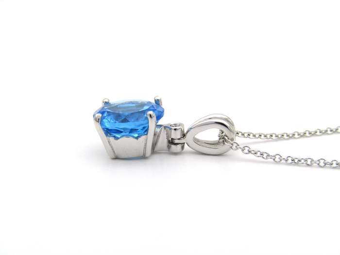9K gold blue topaz and diamond pendant.