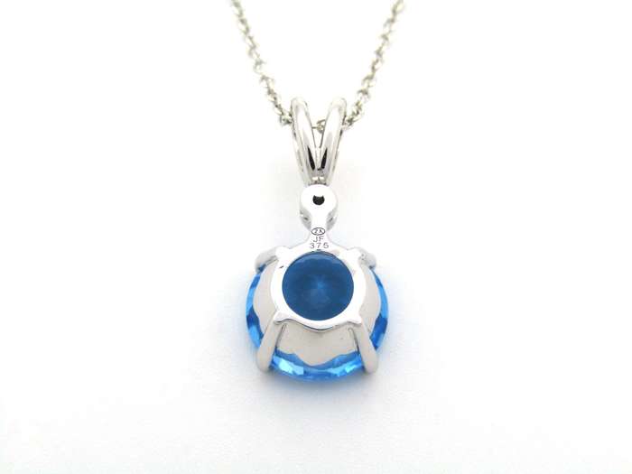 9K gold blue topaz and diamond pendant.