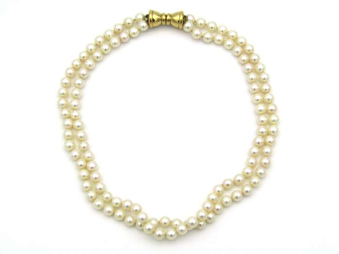 Double strand of pearls with gold plated magnetic clasp.