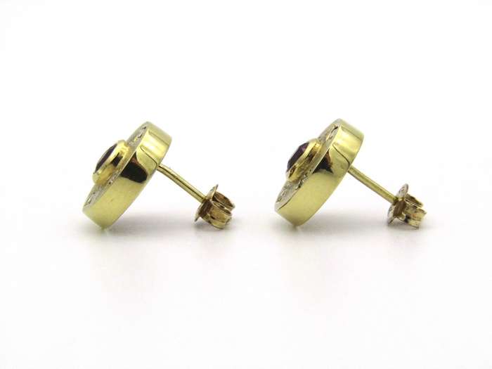 A pair of 18K gold ruby and diamond earrings.