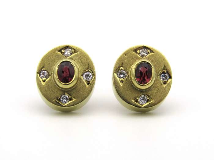 A pair of 18K gold ruby and diamond earrings.