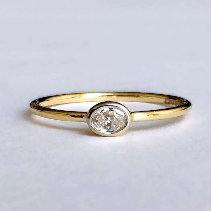 0.25ct Oval Moissanite East West Bezel Ring