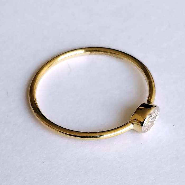 0.25ct Oval Moissanite East West Bezel Ring