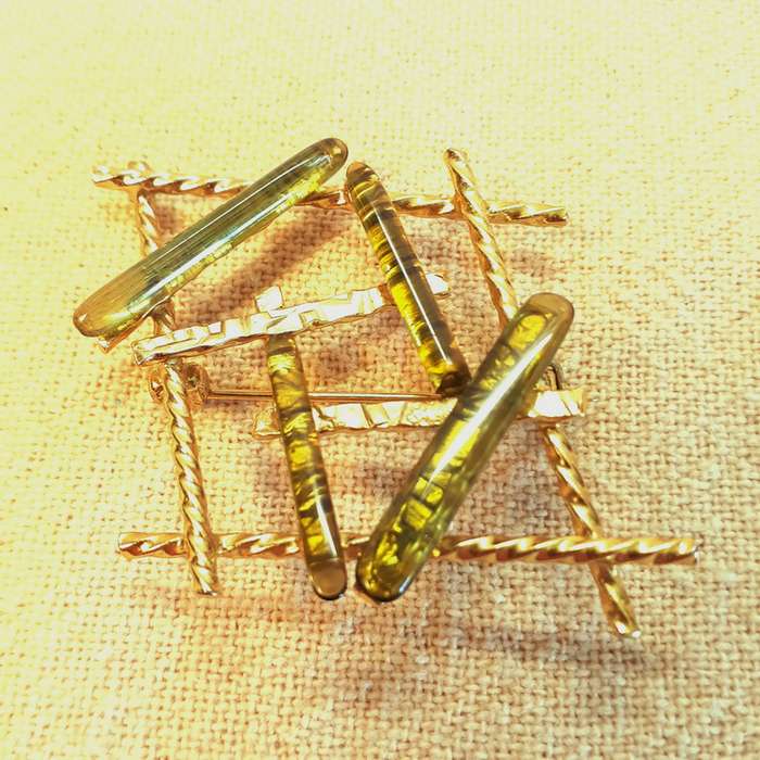 Vintage gold brooch with pale green stones/glass