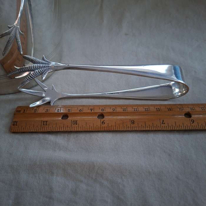 Silver plate ice bucket with tongs.   Quality Louis Silver plate with ice water drainer