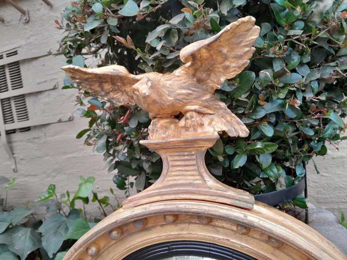 An  English Antique 19th Century Circa 1830s Regency Convex Mirror with Eagle and Ball Detail