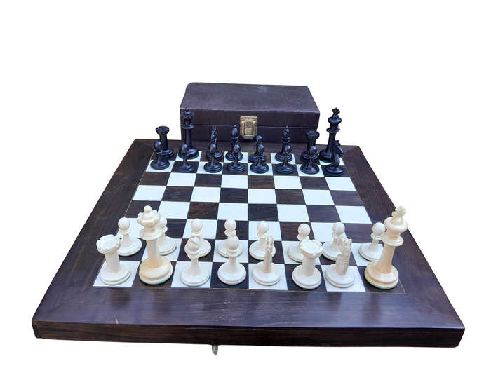 A 20th Century Hand Carved Ebony And Ivory Chess Set With Board And Leather Case