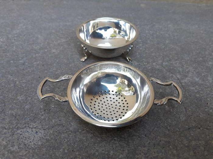 An English Elizabeth II Circa 1956 Georgian-style  Silver Tea Strainer  on Feet  Dimensions: ...