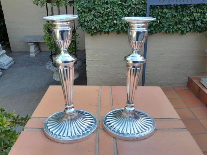 An Early 19th Century Pair of George III Old Sheffield Plated Candlesticks On Loaded Bases