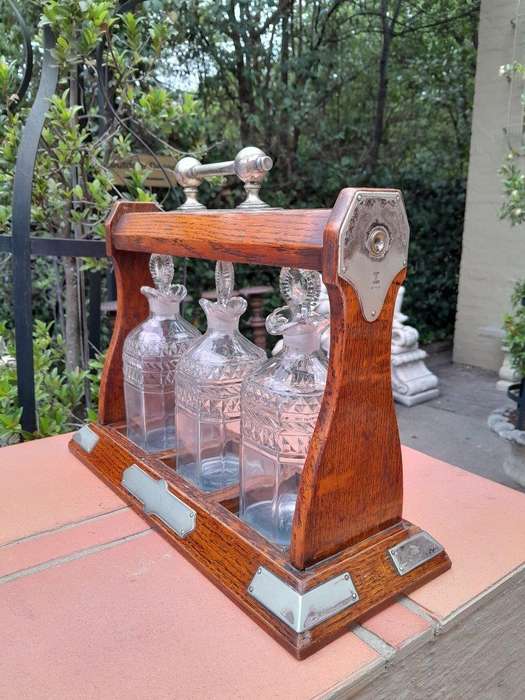 An English Oak Tantalus with 3 Glass Decanters & Metal Hardware