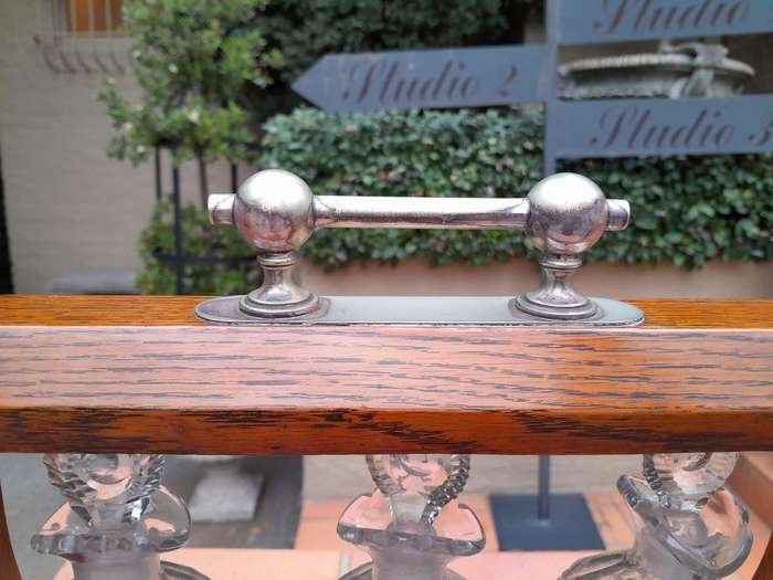 An English Oak Tantalus with 3 Glass Decanters & Metal Hardware