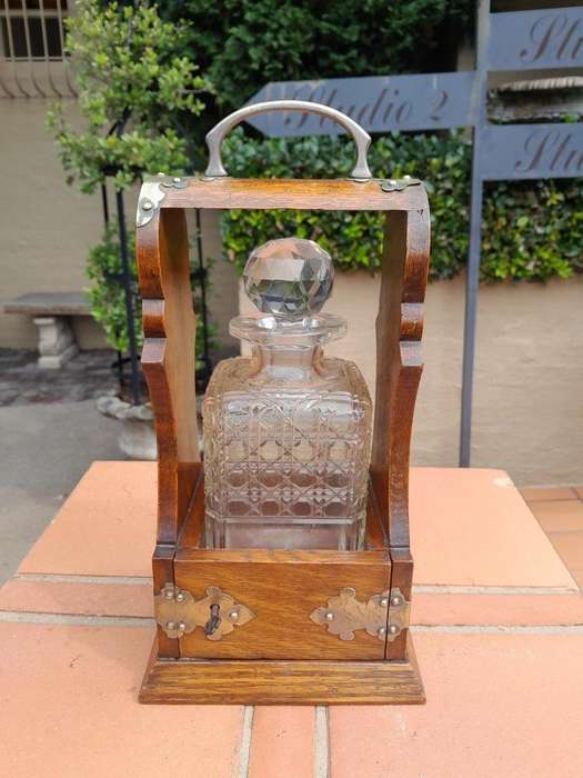 An Antique Victorian Tantalus With A Crystal Decanter And Key