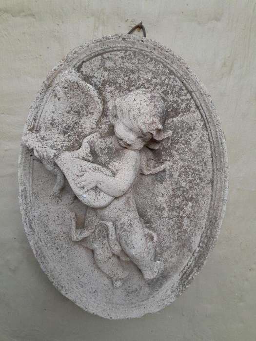A Concrete Relief Oval Sculpture Of An Ornate Cherub Plaque