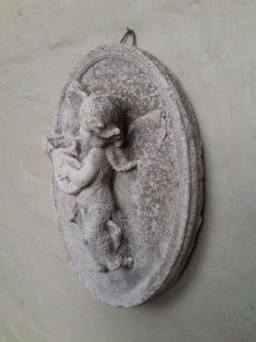 A Concrete Relief Oval Sculpture Of An Ornate Cherub Plaque