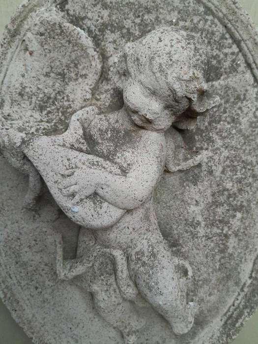 A Concrete Relief Oval Sculpture Of An Ornate Cherub Plaque
