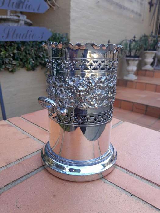 A Silver-Plate Wine Bottle Holder With Two Handles