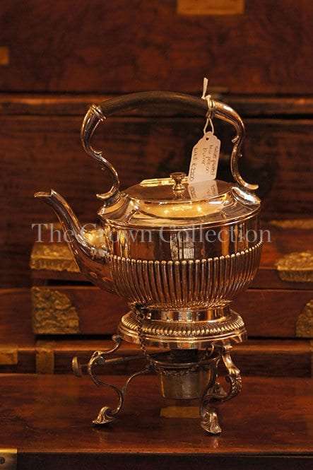 Silver plated tea pot on burner
