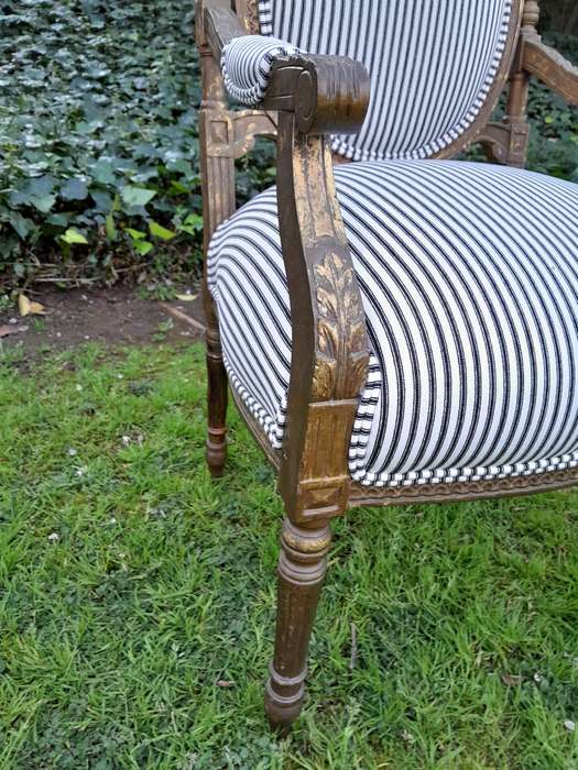 A Pair of 20th Century French Louis XV Style Gilded Armchairs Upholstered in a Ticking Fabric