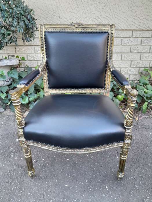 A Pair Of Louis XVI Style Carved And Gilded Armchairs Upholstered in Leather