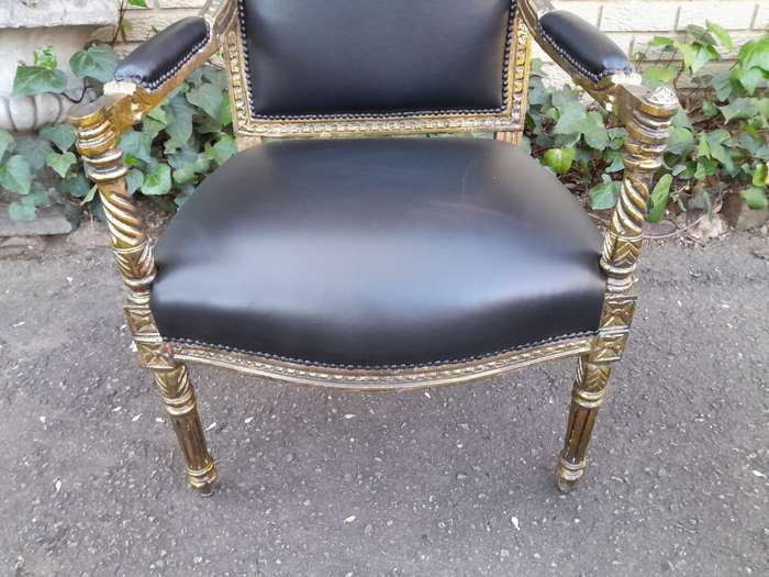 A Pair Of Louis XVI Style Carved And Gilded Armchairs Upholstered in Leather