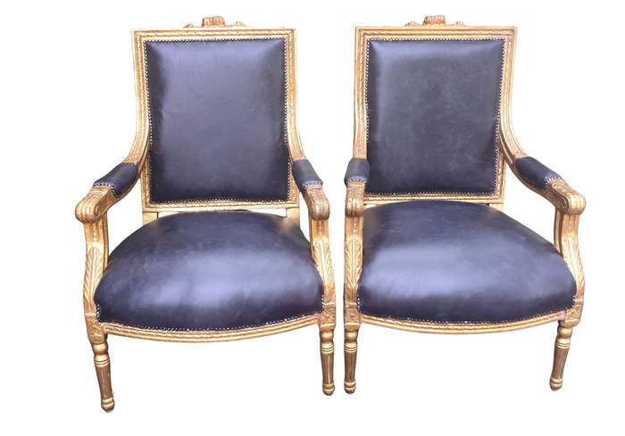A Pair of French Style Gilded Armchairs Upholstered in Leather