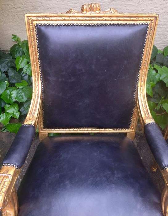 A Pair of French Style Gilded Armchairs Upholstered in Leather