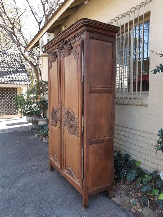 A French Provincial styled Ornately carved Armoire