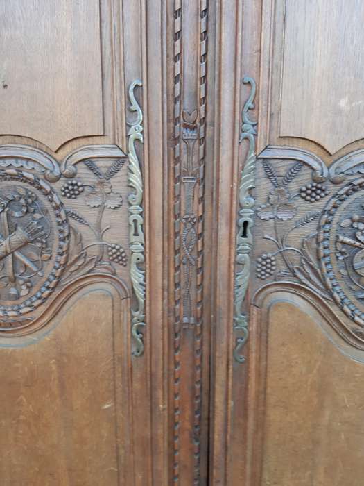A French Provincial styled Ornately carved Armoire
