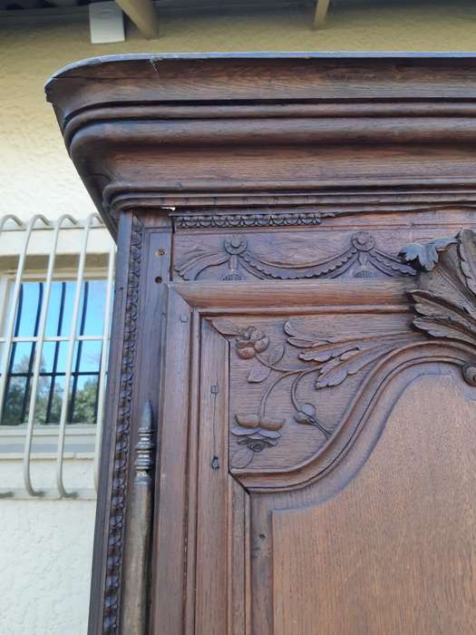 A French Provincial styled Ornately carved Armoire