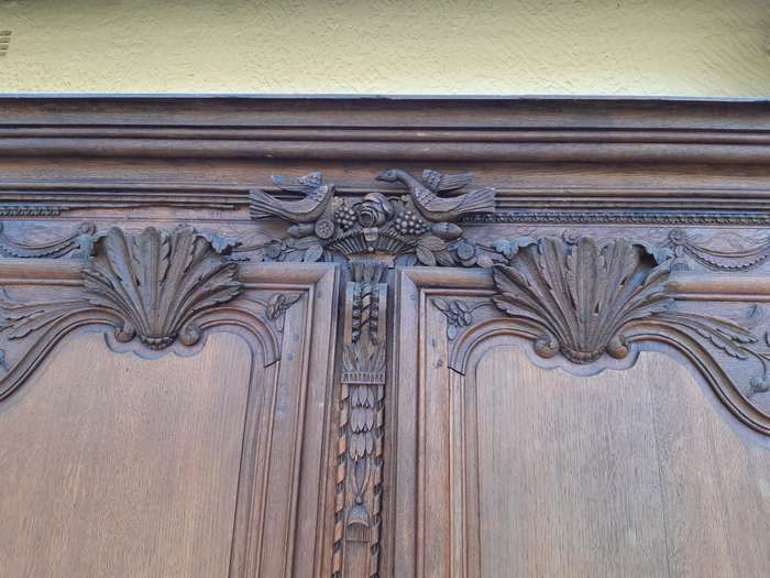 A French Provincial styled Ornately carved Armoire