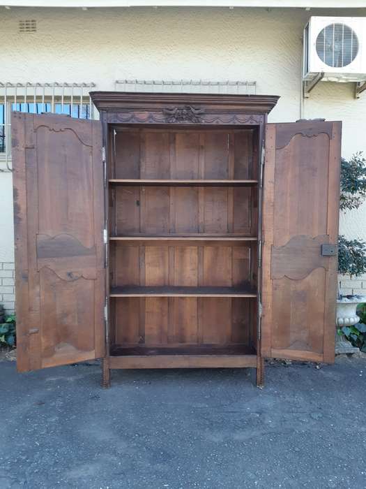 A French Provincial styled Ornately carved Armoire