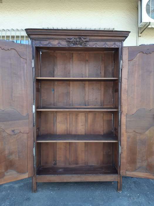 A French Provincial styled Ornately carved Armoire