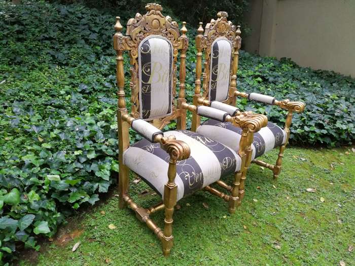 Pair of 19th Century carved teak and gilded in gold leaf open arm throne chairs         ...