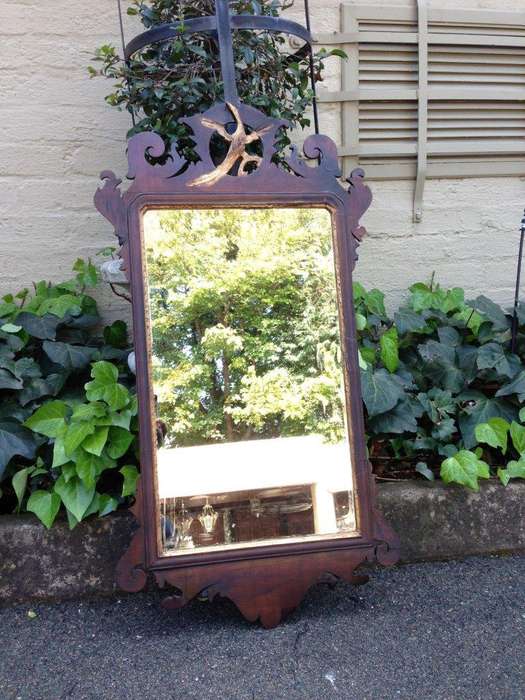 A Georgian mahogany mirror with an eagle