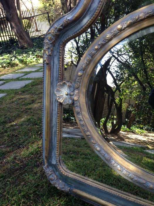 A French Ornate carved painted mirror with a bevelled centre section