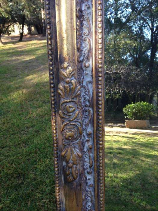An Ornate Carved & Bevelled Painted Mirror