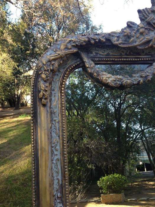 An Ornate Carved & Bevelled Painted Mirror