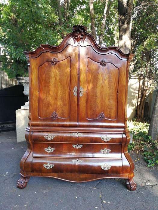 An 18th century (circa 1770) Dutch mahogany cabinet on bombe base/armoire with the original brass...