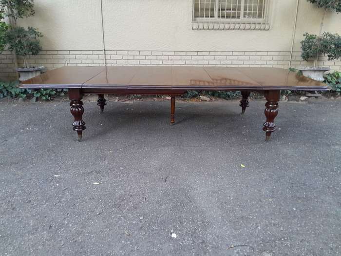A Massive and Rare Victorian Mahogany Dining / Boardroom Extension table with Four Extensions and...