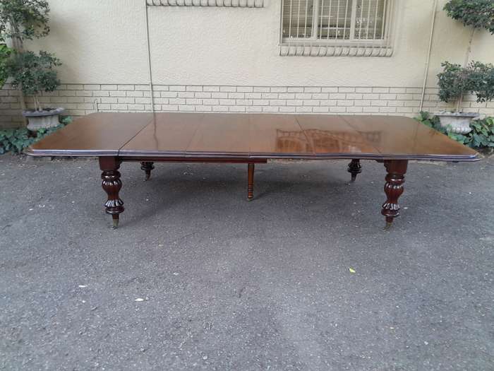 A Massive and Rare Victorian Mahogany Dining / Boardroom Extension table with Four Extensions and...