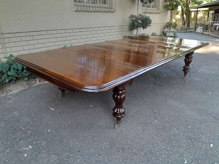 A Massive and Rare Victorian Mahogany Dining / Boardroom Extension table with Four Extensions and...