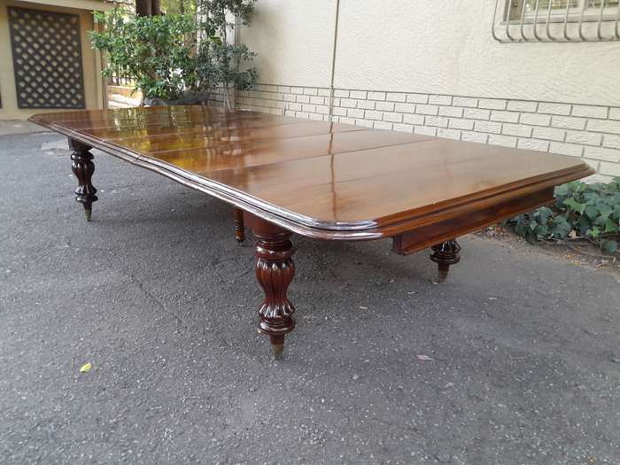 A Massive and Rare Victorian Mahogany Dining / Boardroom Extension table with Four Extensions and...