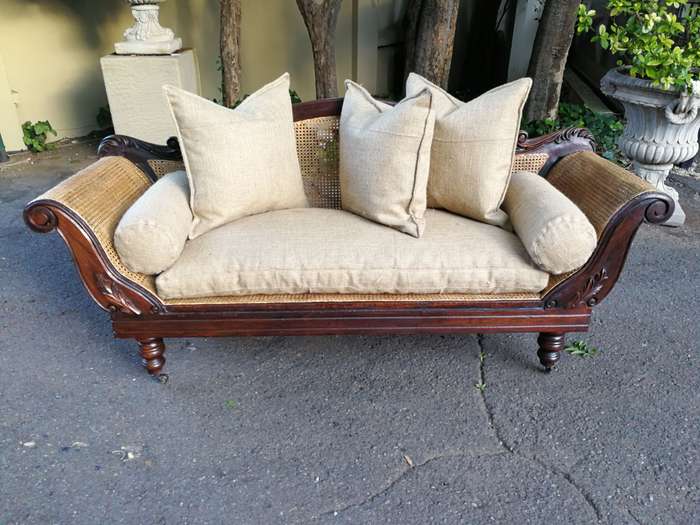 An Antique Victorian Carved Mahogany and Rattan Settee On Castors with Hessian Cushions and Bolsters