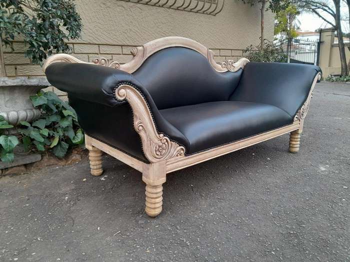 A 20th Century  Carved Mahogany Wooden Settee With Brass Castors, Upholstered In Leather In A Ble...