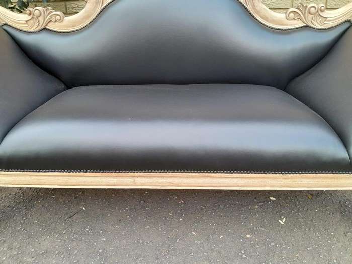 A 20th Century  Carved Mahogany Wooden Settee With Brass Castors, Upholstered In Leather In A Ble...