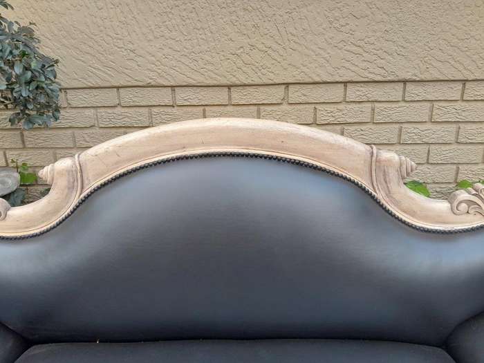 A 20th Century  Carved Mahogany Wooden Settee With Brass Castors, Upholstered In Leather In A Ble...