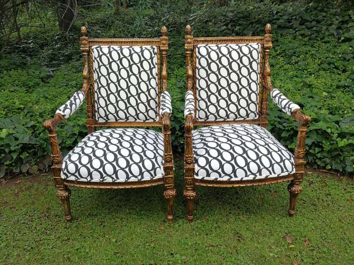 A Pair of French Style Ornately Carved and Gilded Armchairs ND
