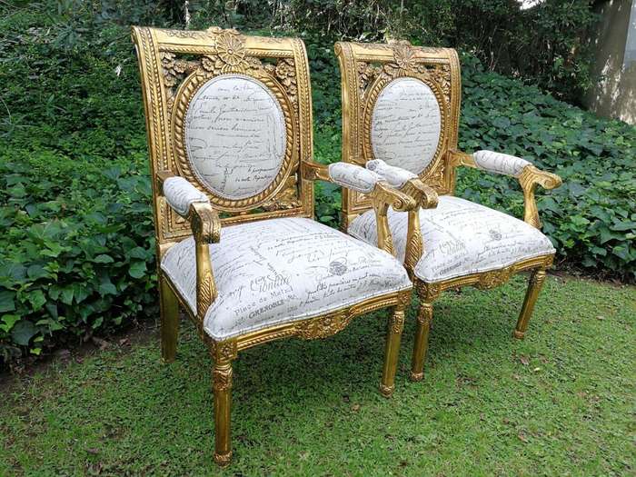 A 20TH Century Pair Of Ornately Carved And Hand Gilded French Style Armchairs Upholstered in a Cu...